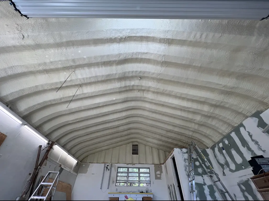 Spray polyurethane foam applied to the underside of a metal roof deck in Humble